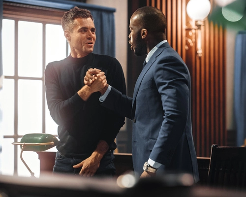 A client and attorney shaking hands after a successful court outcome